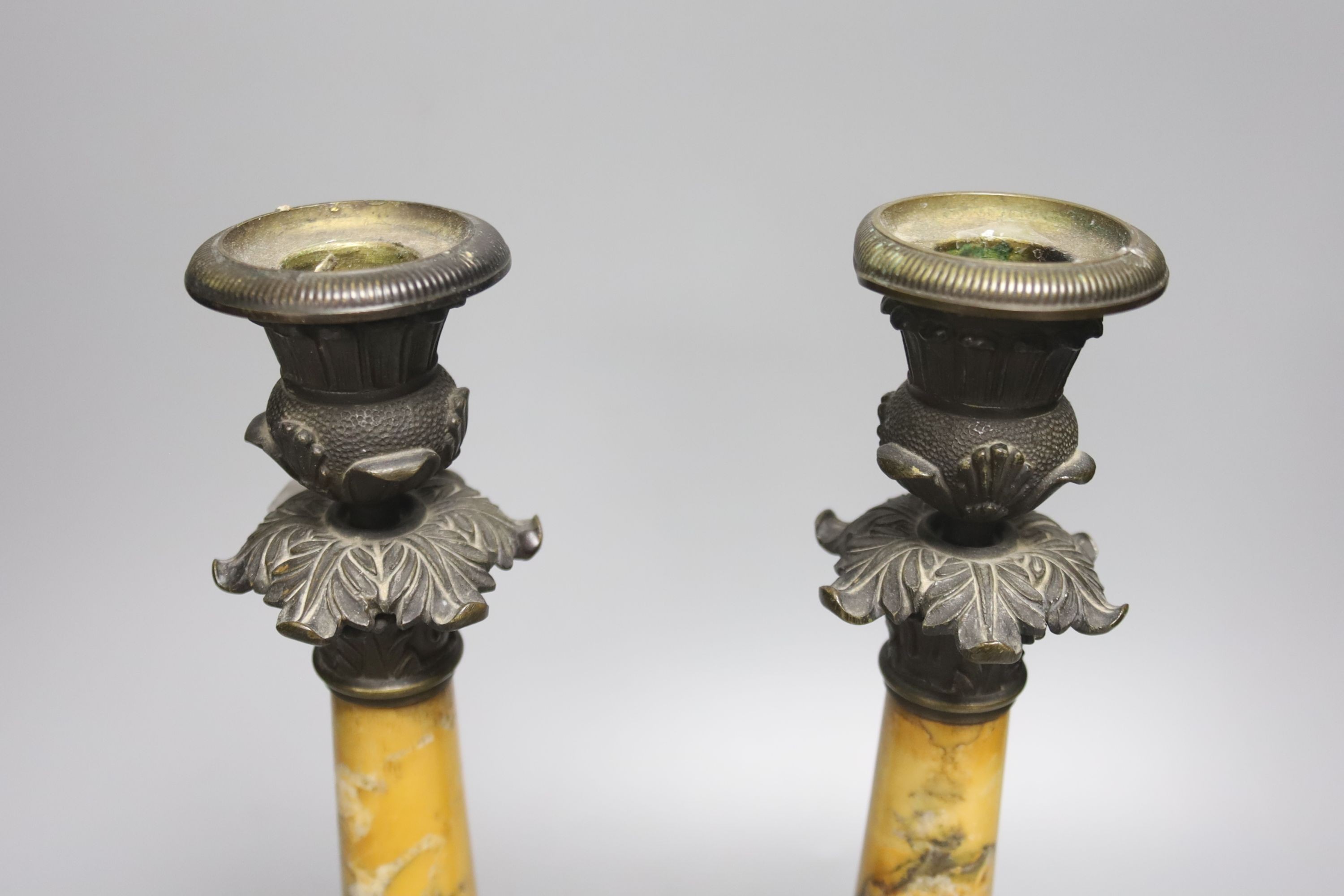 A pair of Empire bronze and Sienna marble candlesticks, height 32cm